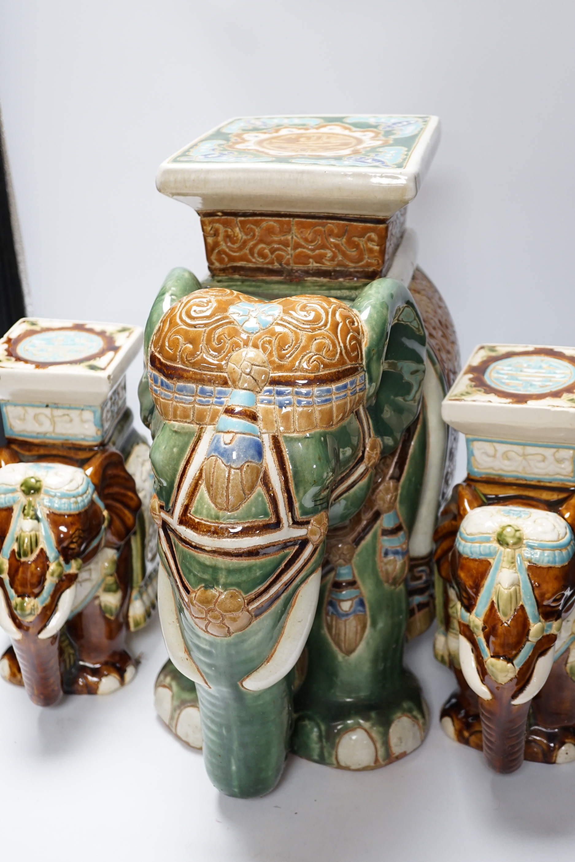 A pair and another elephant and howdah garden seats, largest 43cm